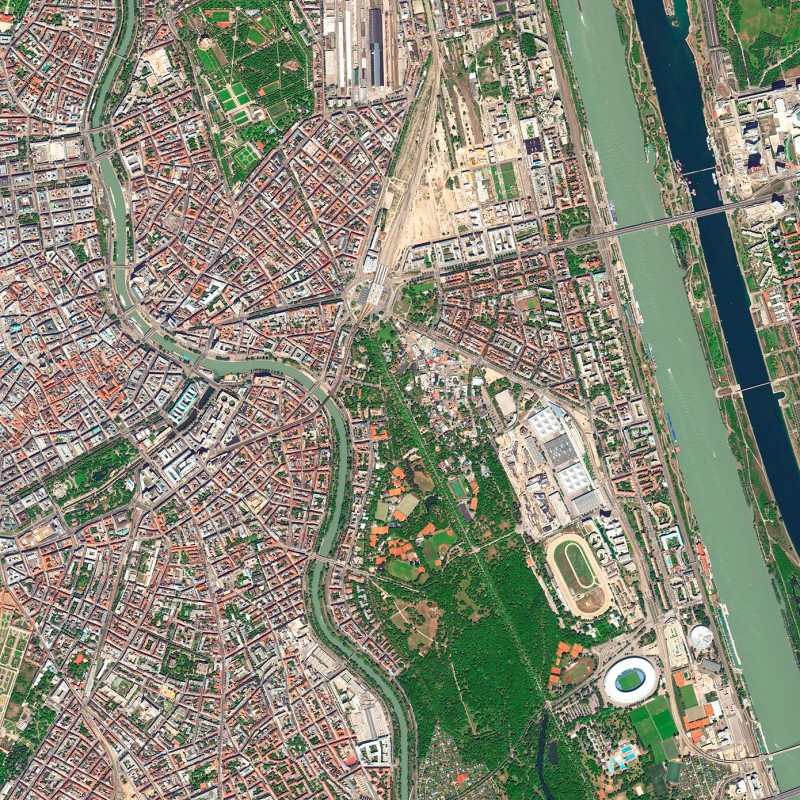 Aerial view of Vienna showing the Danube Island, Danube Canal, and Danube River with visible streets, buildings,
                                 and green areas. (AI-generated alt-text, generated with GPT-4.1-mini)