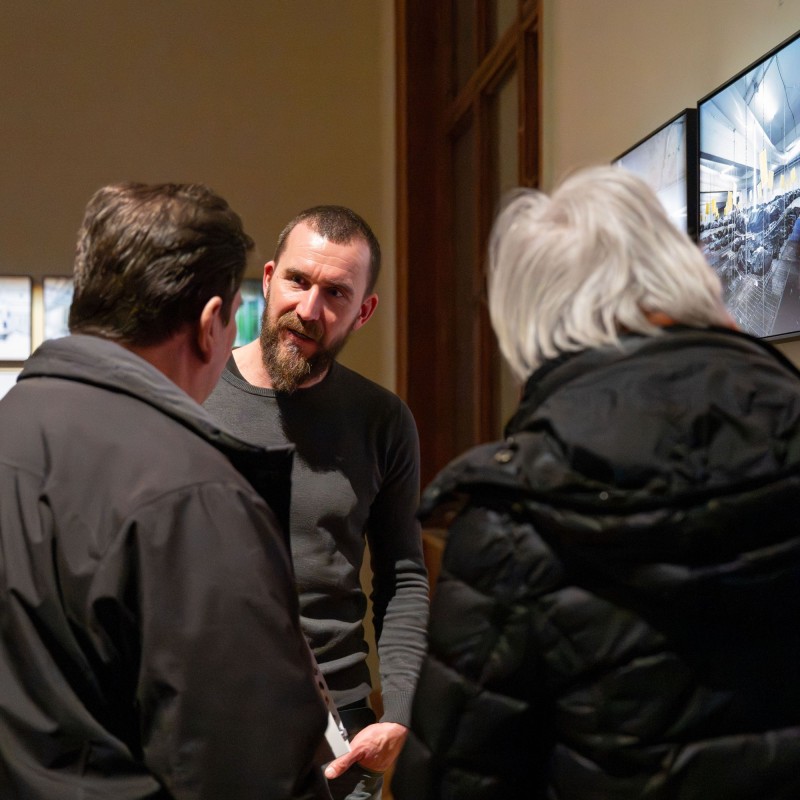 Photographer Gregor Sailer
                                 speaks with visitors to the exhibition