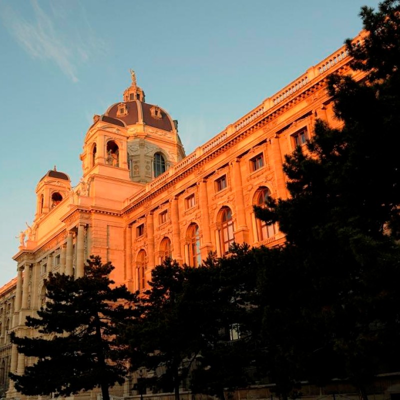 Natural History Museum Vienna in warm evening light, large historic
                                 building with dome, trees in the foreground. (AI-generated alt-text, generated with GPT-4.1-mini)