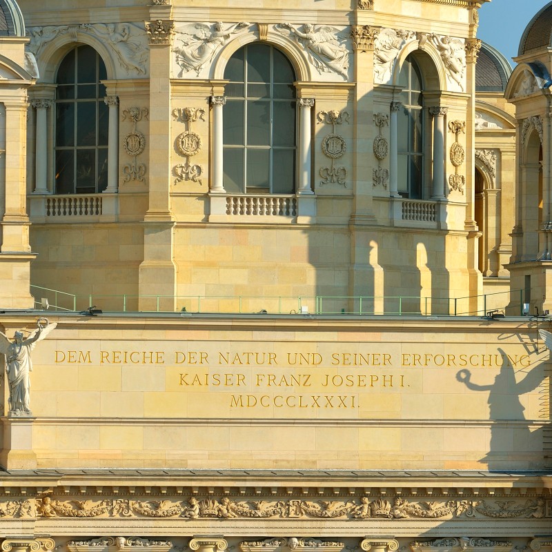 Facade with
                                 beige stone, windows, and a clearly readable inscription, flanked by two angelic figures with outstretched arms. (AI-generated
                                 alt-text, generated with GPT-4.1-mini)