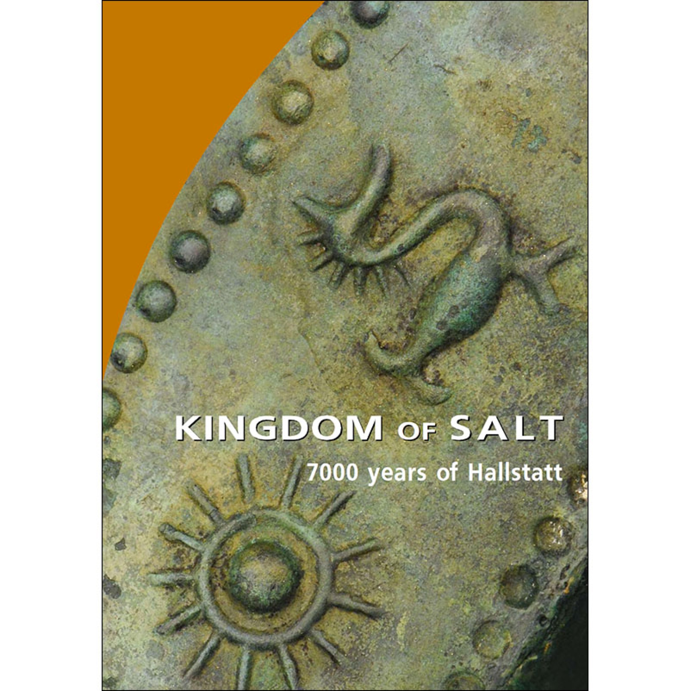 : Close-up of an old metal plaque with decorative embossments including a sun and a twisted figure near the edge (AI-generated alt-text, generated with GPT-4.1-mini)