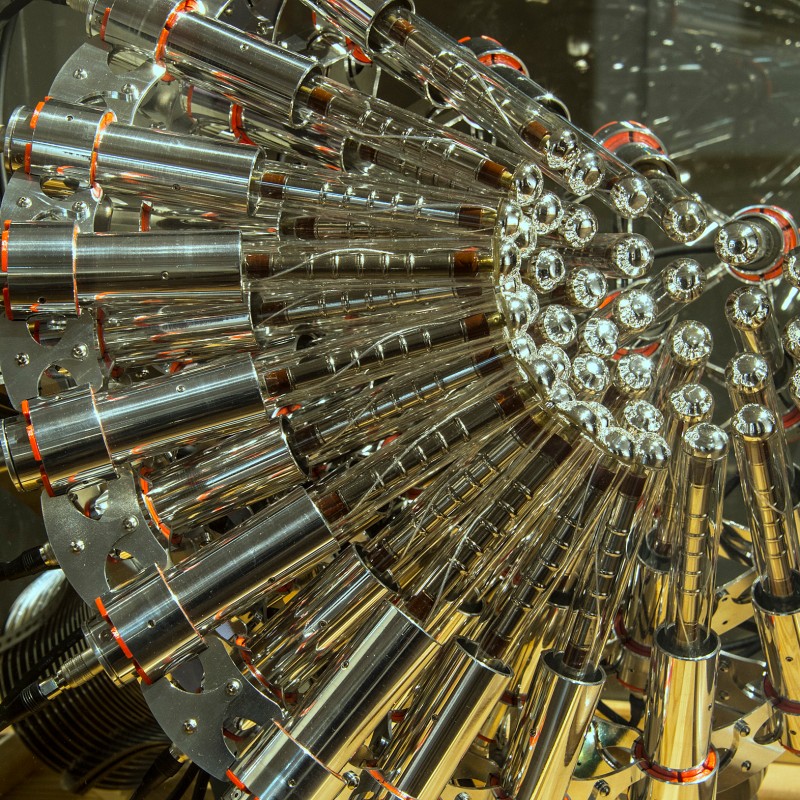 Complex
                                 arrangement of many shiny metal cylinders with reflective surfaces and red rings, photographed at an angle from the front.
                                 (AI-generated alt-text, generated with GPT-4.1-mini)