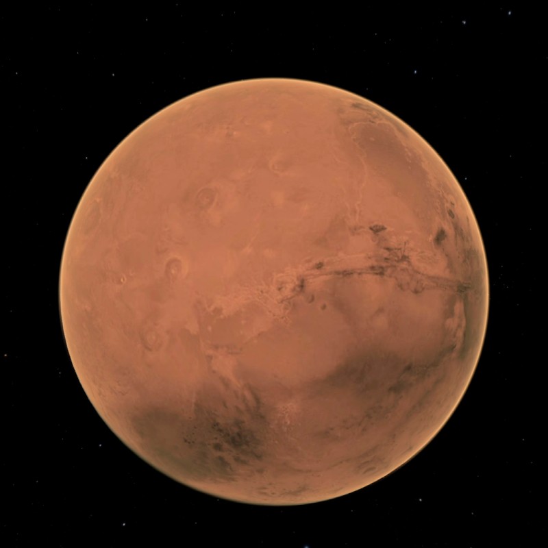 Reddish-orange spherical Mars planet against black starry background. (AI-generated alt-text, generated with GPT-4.1-mini)
