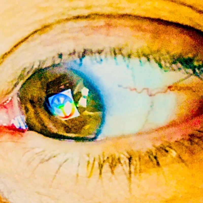 Close-up of a human eye with visible blood vessels and reflections of colorful symbols on the cornea. (AI-generated
                                 alt-text, generated with GPT-4.1-mini)